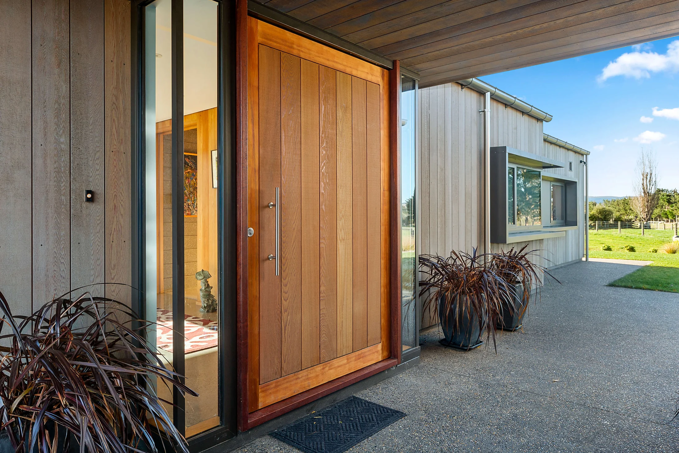 Solid timber entrance door framed by considered architectural details